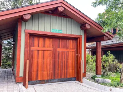a garage with a wooden door on a house at Juniper Crest 6 Apartment in Mammoth Lakes
