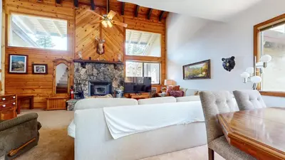 a living room with white furniture and a fireplace at Mammoth Reservations in Mammoth Lakes