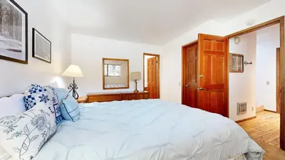 a bedroom with a large bed with blue pillows at Mammoth Reservations in Mammoth Lakes