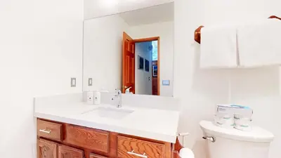 a white bathroom with a sink and a mirror at Mammoth Reservations in Mammoth Lakes