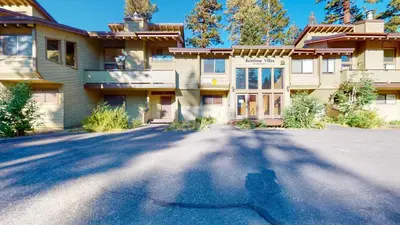 a large house with a driveway in front of it at Mammoth Reservations in Mammoth Lakes