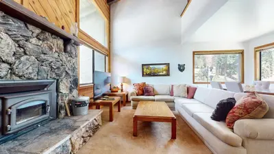 a living room with a couch and a fireplace at Mammoth Reservations in Mammoth Lakes