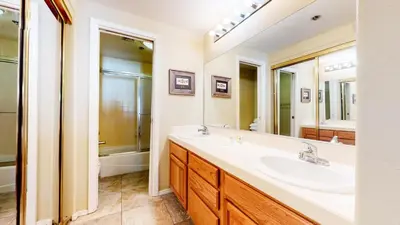 a bathroom with a sink and a mirror and a tub at Mammoth Reservations in Mammoth Lakes