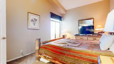 a bedroom with a bed and a large mirror at Mammoth Reservations in Mammoth Lakes