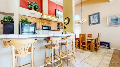 a kitchen with a bar and a dining room at Mammoth Reservations in Mammoth Lakes