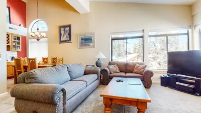 a living room with a couch and a tv at Mammoth Reservations in Mammoth Lakes