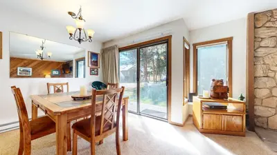 a dining room with a wooden table and chairs at Mammoth Reservations in Mammoth Lakes