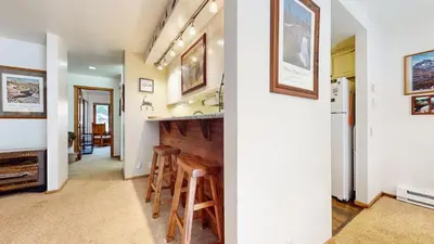 a kitchen and a living room with a bar in a house at Mammoth Reservations in Mammoth Lakes