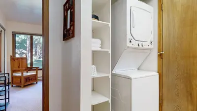 a room with a white pantry with a refrigerator at Mammoth Reservations in Mammoth Lakes