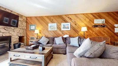 a living room with a couch and a fireplace at Mammoth Reservations in Mammoth Lakes