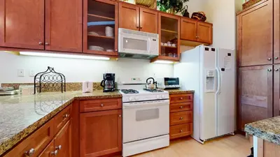 a kitchen with white appliances and wooden cabinets at Snowcreek 1005 Apartment in Old Mammoth