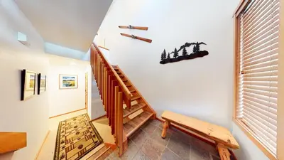a staircase in a house with a wooden stair case at Snowcreek 1005 Apartment in Old Mammoth