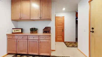a kitchen with wooden cabinets and a door at Snowcreek 1005 Apartment in Old Mammoth