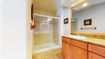a bathroom with a shower and a sink and a mirror at Snowcreek 1005 Apartment in Old Mammoth
