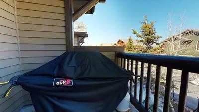 an umbrella sitting on the side of a porch at Snowcreek 1005 Apartment in Old Mammoth