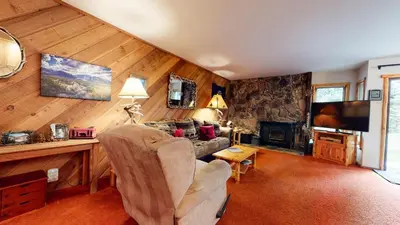 a living room with a couch and a television in a room at Snowcreek 253 Apartment in Mammoth Lakes