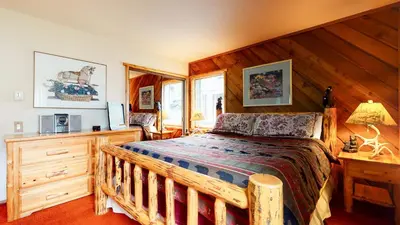 a bedroom with a wooden bed in a room at Snowcreek 253 Apartment in Mammoth Lakes