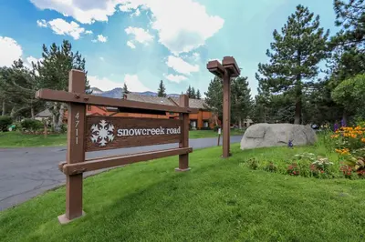 a sign in the grass next to a street at Snowcreek 253 Apartment in Mammoth Lakes