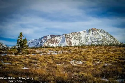 a snow covered mountain in the middle of a field at Snowcreek 253 Apartment in Mammoth Lakes