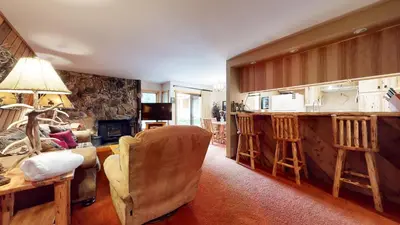 a kitchen and living room with a couch and a table at Snowcreek 253 Apartment in Mammoth Lakes