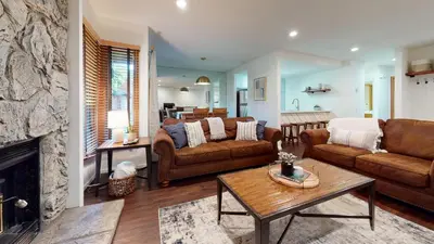 a living room with brown furniture and a fireplace at Snowcreek 441 Apartment in Old Mammoth