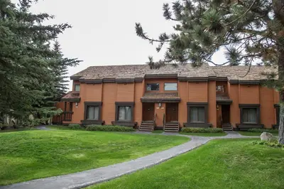 a large house with a lawn in front of it at Snowcreek 441 Apartment in Old Mammoth