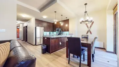 a kitchen and dining room with a table and a couch at Solstice 10 Apartment in Mammoth Lakes
