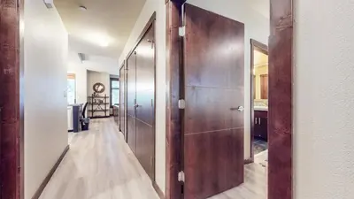 a hallway with wooden doors in a house at Solstice 10 Apartment in Mammoth Lakes