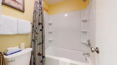 a bathroom with a tub and a toilet and a shower at Summit 3 Apartment in Mammoth Lakes