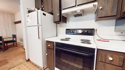 a kitchen with a stove and a refrigerator at Mammoth Reservations in Mammoth Lakes