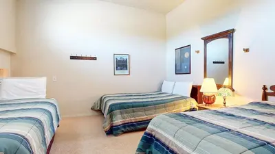 a room with two beds and a mirror at Summit 34 Apartment in Mammoth Lakes