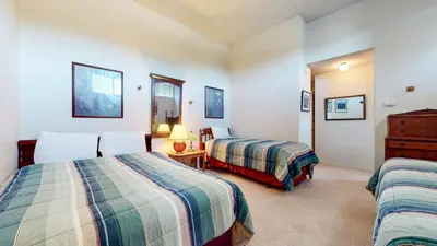 a hotel room with two beds and a dresser at Summit 34 Apartment in Mammoth Lakes