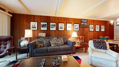 a living room with a couch and a chair at Summit 45 Apartment in Mammoth Lakes