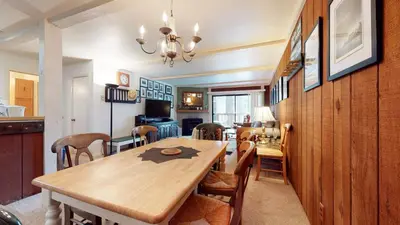 a dining room with a wooden table and chairs at Summit 45 Apartment in Mammoth Lakes
