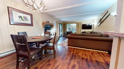 a living room with a table and a couch at Summit 49 Apartment in Mammoth Lakes