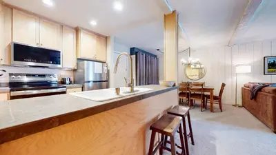 a kitchen with a sink and a stove top oven at Summit 55 Apartment in Mammoth Lakes