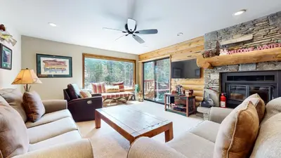 a living room with couches and a fireplace at Summit 81 Apartment in Mammoth Lakes