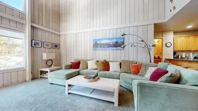 a living room with a couch and a table at Mammoth Reservations in Mammoth Lakes