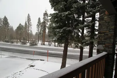 a view of a snow covered road with trees at Summit 211 Apartment in Mammoth Lakes