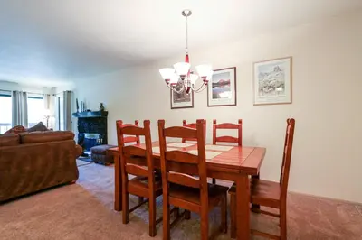 a dining room with a table and chairs at Summit 211 Apartment in Mammoth Lakes