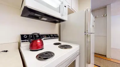 a tea kettle is sitting on top of a stove in a kitchen at Mammoth Reservations in Mammoth Lakes