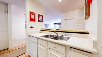a kitchen with white cabinets and a sink at Mammoth Reservations in Mammoth Lakes