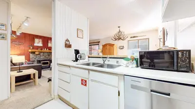 a kitchen with a sink and a microwave at Rustic Summit 237 On Free Shuttle Route in Mammoth Lakes