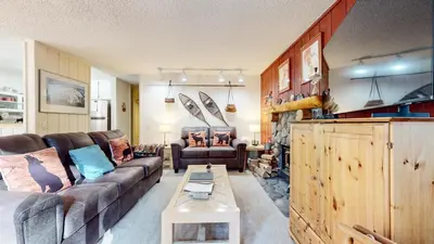 a living room with a couch and a table at Rustic Summit 237 On Free Shuttle Route in Mammoth Lakes
