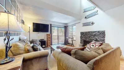 a living room with two couches and a fireplace at Mammoth Reservations in Mammoth Lakes