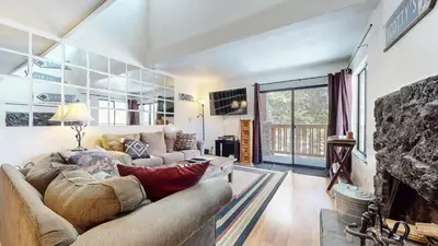 a living room with a couch and a fireplace at Mammoth Reservations in Mammoth Lakes