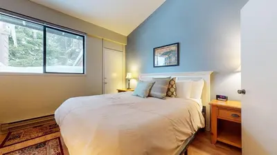 a bedroom with a large bed and a window at Mammoth Reservations in Mammoth Lakes