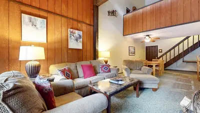 a living room with couches and a table at Mammoth Reservations in Mammoth Lakes