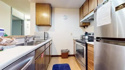 a small kitchen with a sink and a stove at Mammoth Reservations in Mammoth Lakes