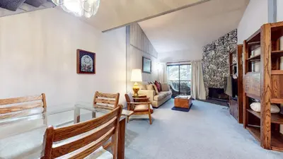 a living room with a glass table and a couch at Mammoth Reservations in Mammoth Lakes